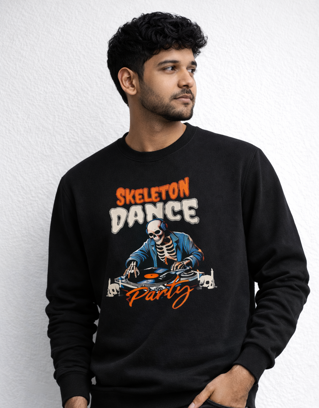 Man wearing a black sweatshirt with skeleton dance party design on a white background